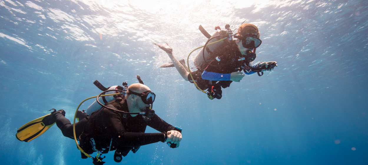 Two young adventures diving in the warm waters of Egypt while on a school trip